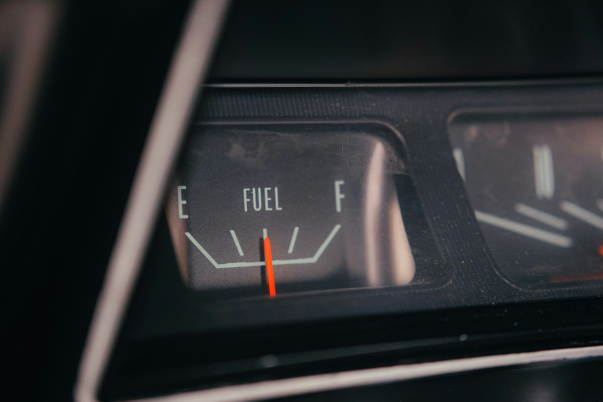 Close-up of a car's fuel gauge showing empty